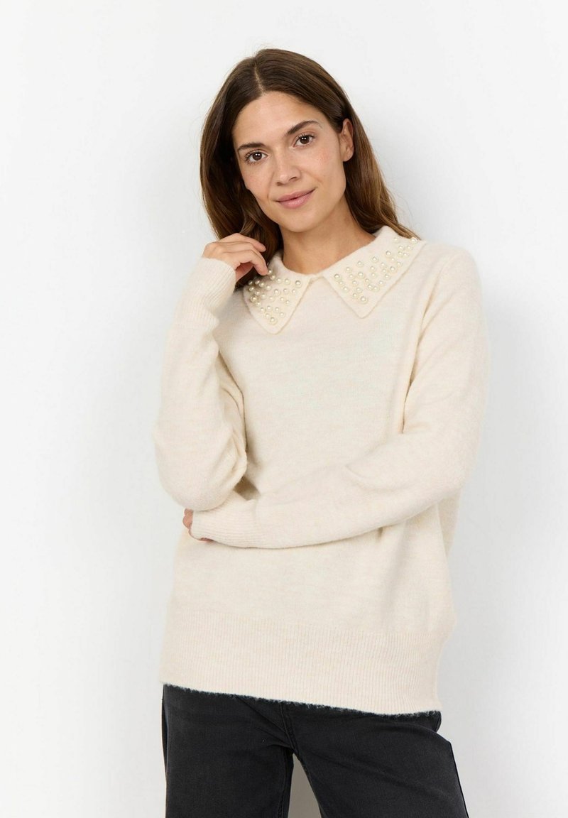 Cream sweater with a collared neckline adorned with bead accents. Features long sleeves and a relaxed fit. Soft knit texture.