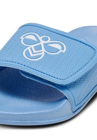 Light blue slide sandal with a textured strap featuring a white logo. Soft material, rounded shape, and a smooth footbed for comfort.