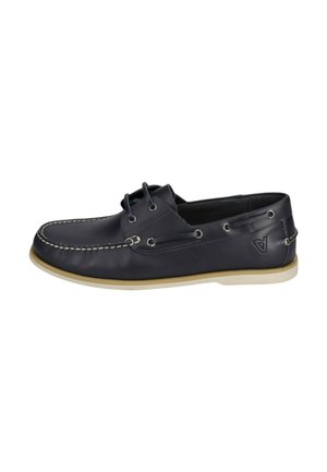 Chaussure bateau en cuir noir avec semelle beige, détails en lacets autour du talon, coutures blanches sur l'avant et logo sur le côté.