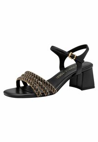 Sandale en cuir noir avec trois brides perlées présentant des accents dorés, un talon bloc et une boucle dorée sur la bride de cheville réglable.