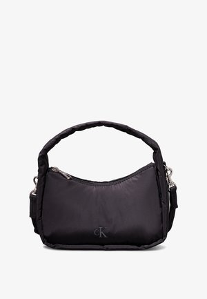 Sort nylonhåndtaske med kort polstret håndtag, aftagelig skulderrem, sølvlynlås og diskret CK-logo foran.