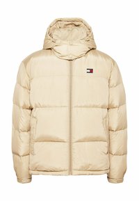 Beige puffer jacket with a hood, zip closure, ribbed cuffs, and a small logo patch on the chest. Features a smooth texture and quilted design.