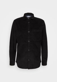 Musta mannapuuvillapaita, jossa on nappikauluskäänne, edessä napit, pitkät hihat ja vasemmalla rinnassa tasku. Rakenne on kohokuvioitua ribbineulosta.