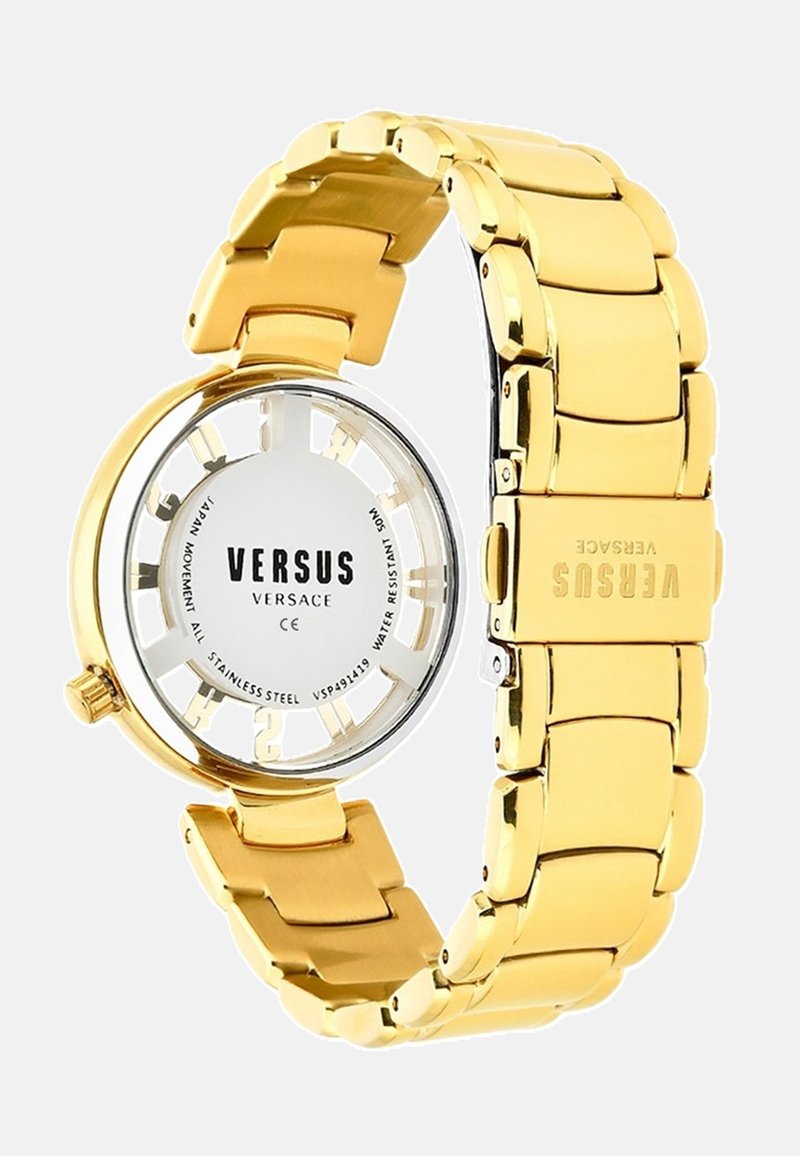 Gold stainless steel watch with a round case, open dial showcasing VERSUS branding, and a chunky link bracelet design. Water-resistant.