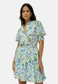 Vestido de manga corta hecho de un tejido ligero, con un patrón floral en azul y verde, con un cierre de botones en la parte delantera y cintura fruncida.