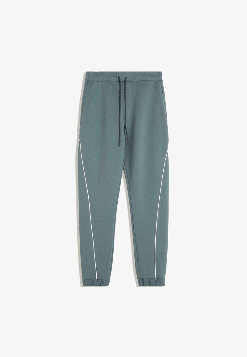 Turkizne trenirke iz mehkega materiala, s tapered krojem, belimi stranskimi črtami, elastičnimi manšetami in pasom na vrvico.