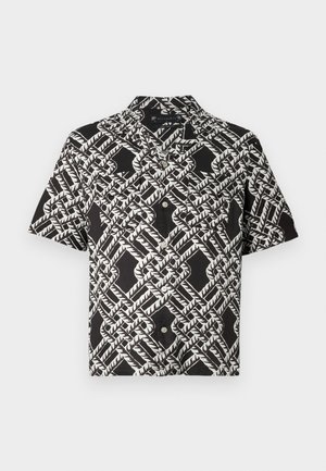 Chemise noire à manches courtes avec un motif géométrique abstrait de feuilles blanches et deux poches poitrine.