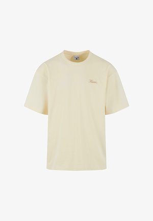 Koszulka z krótkim rękawem, okrągłym dekoltem, w jasnym żółtym kolorze, wykonana z bawełny, z delikatnym logo na lewej piersi w uzupełniającym beżowym odcieniu.