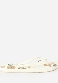 Tongs blanches avec un design floral en beige et marron, dotées d'une semelle plate et de brides en thong douces pour un enfilage facile.