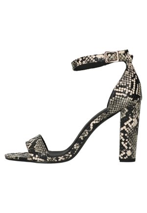 Black and white snakeskin-patterned high-heeled sandal with an ankle strap and square toe, featuring a block heel with a smooth texture.