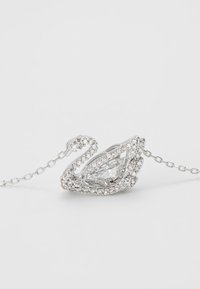 Swan pendant in silver with a pear-shaped clear crystal centerpiece, surrounded by small clear rhinestones, attached to a delicate chain.
