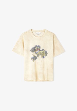 T-shirt beige a maniche corte in cotone con un motivo astratto colorato blu e verde al centro. Tessuto morbido, vestibilità rilassata.