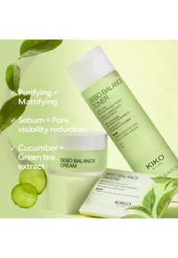 Produits de soin de la peau écologiques comprenant une bouteille de tonique, un pot de crème et des feuilles matifiantes. Les étiquettes mettent en avant les ingrédients et leurs effets ; surfaces lisses, couleurs pastel.