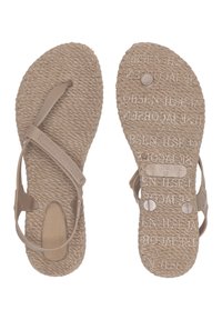 Light beige sandals with a textured, woven sole and rubber straps. Features embossed text on the footbed and decorative buttons.