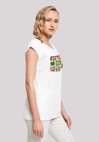White cotton t-shirt featuring a colorful cartoon character graphic in a grid pattern on the front, short sleeves, and a relaxed fit.