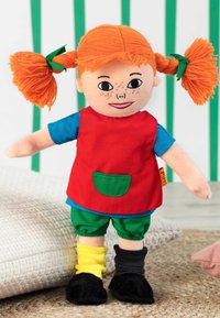 Doll with orange yarn hair in pigtails, wearing a red shirt, green shorts, and mismatched black and yellow socks. Features freckled face.
