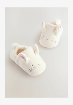 Soft, cream-colored plush slippers with bunny ears. Features embroidered face details and a cozy lining for comfort.
