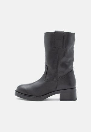 Black leather ankle boot with a square toe, low block heel, side elastic panels, and a pull tab at the back for easy wear.