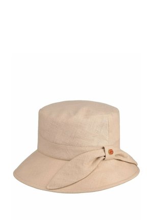 Beige linen bucket hat with wide brim and decorative fabric knot secured by small round red and gold emblem.