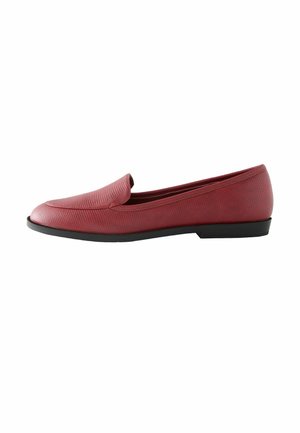 Red slip-on loafer with ribbed texture, rounded toe, low black sole, and a minimalistic design. Ideal for casual or semi-formal wear.