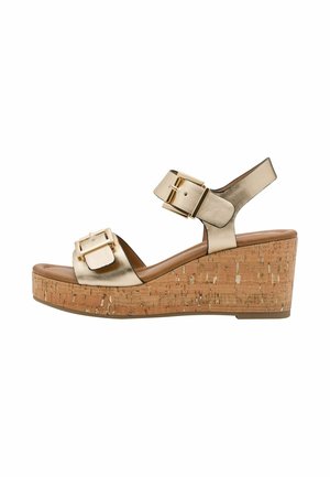 Sandales compensées dorées métalliques avec plateforme en liège, doubles brides réglables, boucles carrées, bout ouvert et finition lisse.