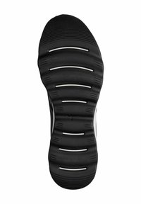 Suola di scarpa nera con superficie testurizzata, caratterizzata da scanalature sollevate e accenti bianchi. Progettata per offrire trazione e flessibilità nei movimenti.