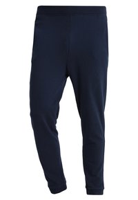 Marineblauwe, taps toelopende joggers gemaakt van zachte stof met een elastische tailleband. Beschikt over omgeslagen enkels en minimale stikdetails.