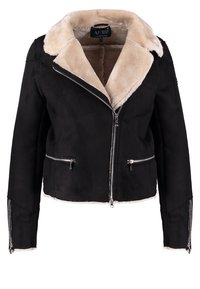 Svart mockajacka med en beige fuskpälskrage, dragkedja framtill och två sidofickor med silverfärgade detaljer.