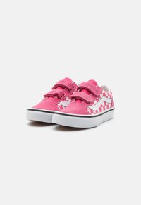 Scarpe in suede e tessuto rosa con cinturini in velcro, caratterizzate da un motivo a scacchi bianco e un dettaglio a swoosh bianco, su una suola bianca e nera.