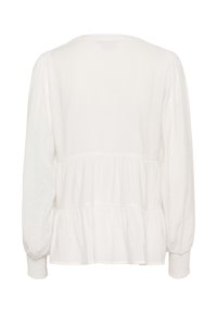 White long-sleeve blouse with a rounded neckline, gathered bodice, and smocked cuffs, featuring a soft texture and flowing silhouette.
