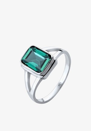 Bague en argent avec une grande pierre précieuse rectangulaire verte émeraude montée sur une bague à fente, marquée 925 à l'intérieur de la bague.