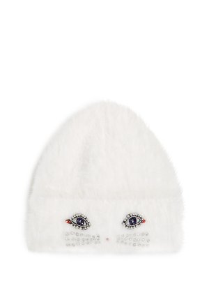 White faux fur beanie featuring embroidered eye design and rhinestone accents on the front, with a rounded top and textured finish.