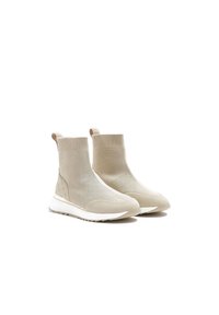 Beige kotníkové boty ve stylu ponožek s texturovaným pleteným svrškem, hladkými semišovými akcenty a bílou gumovou podrážkou. Obsahují poutka pro snadné obouvání.