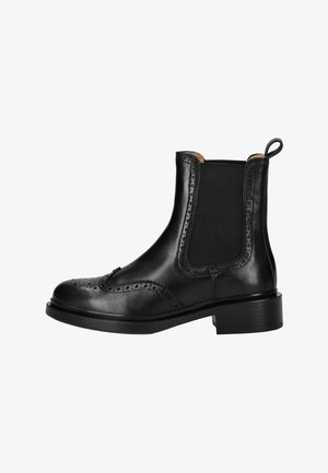Bottines Chelsea en cuir noir avec des détails perforés et des panneaux élastiques sur les côtés. Bout arrondi, languette de tirage et petit talon rectangulaire. Texture lisse.