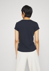 Navy blue short-sleeve T-shirt with a round neckline, made of soft material, featuring a relaxed fit and simple design.
