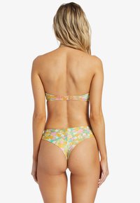 Bikini top and bottom in multi-colored floral pattern. Material is smooth with a glossy finish. Back features a clasp closure.