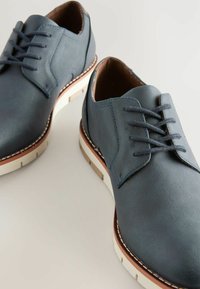 Blue leather shoes with a smooth texture, round toe, and lace-up design. White outsole with brown accents and contrast stitching.