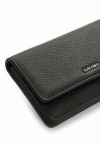 Black leather wallet with a textured finish, featuring a fold-over design and silver "SURI FREY" branding on the front.