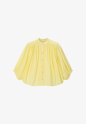 Light yellow loose blouse with long puffed sleeves, button-down front, and gathered fabric detail at shoulders and cuffs.