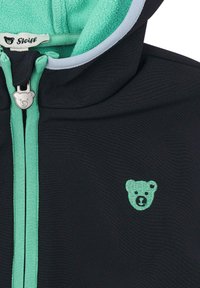 Felpa nera con cappuccio in pile, con dettagli turchesi e logo di un orso. Con zip frontale e tessuto testurizzato per calore e comfort.