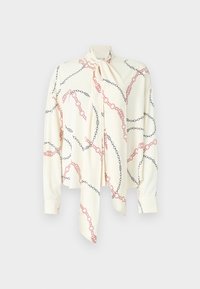 Blusa crema con colletto a cravatta, caratterizzata da un motivo a catena nero e rosso. Maniche lunghe con polsini a bottoni, tessuto dalla texture liscia.