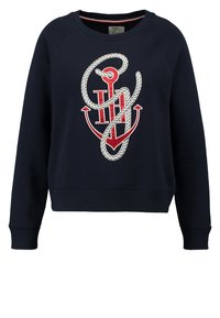 Navy sweatshirt with a red anchor and white rope design wrapped around the initials "TH" on the front.