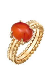 Bague en or avec une pierre orange ovale lisse, ornée d'un bandeau texturé composé de petites perles entrelacées autour.