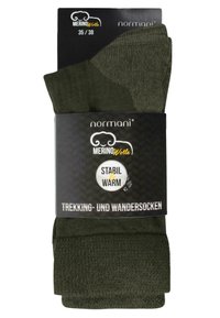 Grüne Merinowoll-Wander- und Trekkingsocken mit Ripptextur, verpackt in schwarzem Material mit der Aufschrift "STABIL & WARM" in weißer Schrift.