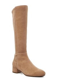 Knee-high, beige suede boot with a rounded toe, stacked heel, and smooth texture. Side seam detail and clean design.