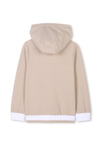 Giacca cappuccio beige con una texture liscia, caratterizzata da polsini e orli bianchi elasticizzati, design semplice e stile minimalista.