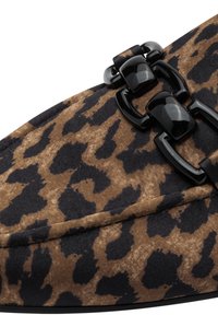 Leopard print shoe with a brown and black fabric upper, featuring a chunky black buckle detail and a sleek, tapered silhouette.