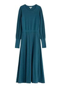 Aukso spalvos megztas suknelė su ilgomis, pūstomis rankovėmis, turinčiomis ribotą tekstūrą. Prigludusi liemenė ir platėjanti sijonas. Apvalus kaklas ir iki vidurio blauzdos ilgio.