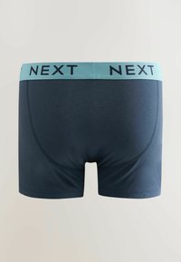 Boxer bleu marine pour homme avec une taille bleu clair portant le mot « NEXT » en lettres noires, vu de dos.