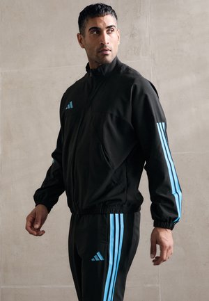 HOUSE OF TIRO WOVEN - Training jacket - black/bright cyan